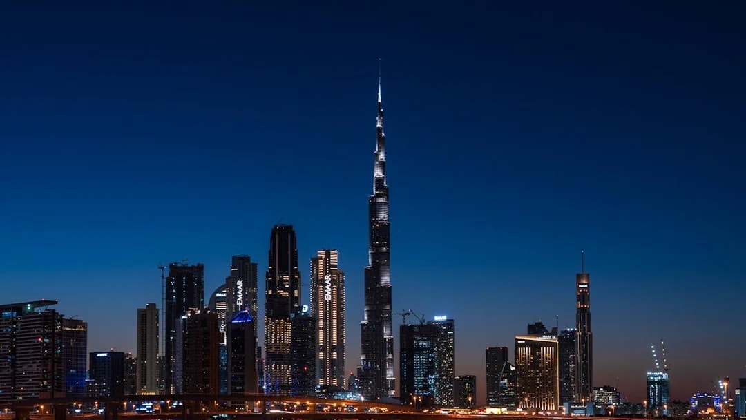 Dubai skyline at night featuring the illuminated Burj Khalifa on the Big Bus Dubai Night Tour.