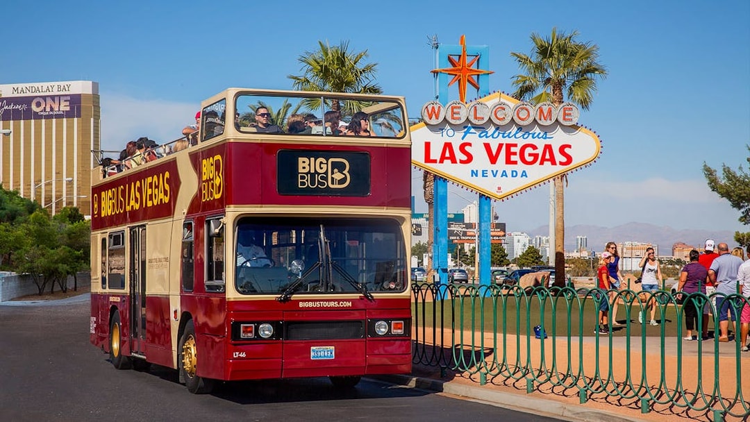 Las Vegas hop-on hop-off bus near Welcome to Fabulous Las Vegas sign.