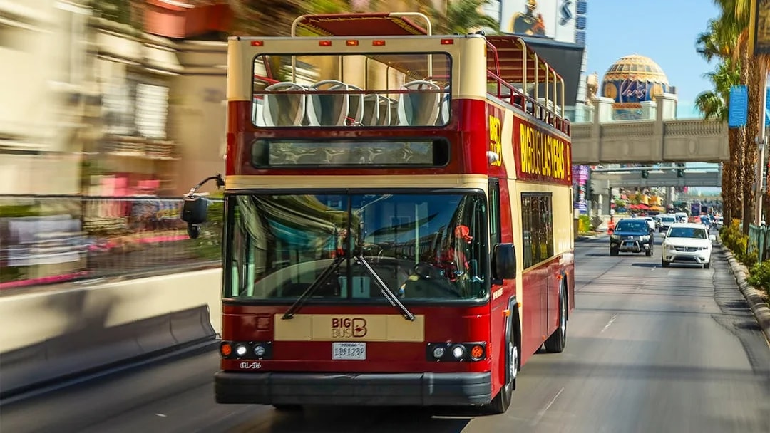 Las Vegas double-decker bus on a city street during a hop-on hop-off tour.