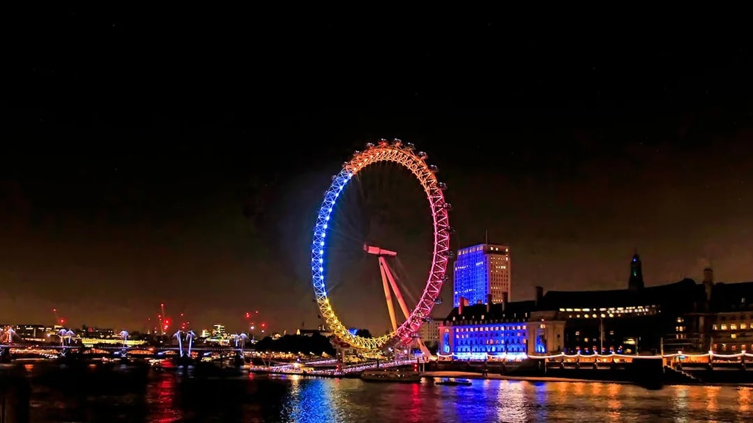 London Eye illuminated at night during Big Bus Panoramic Evening Tour.