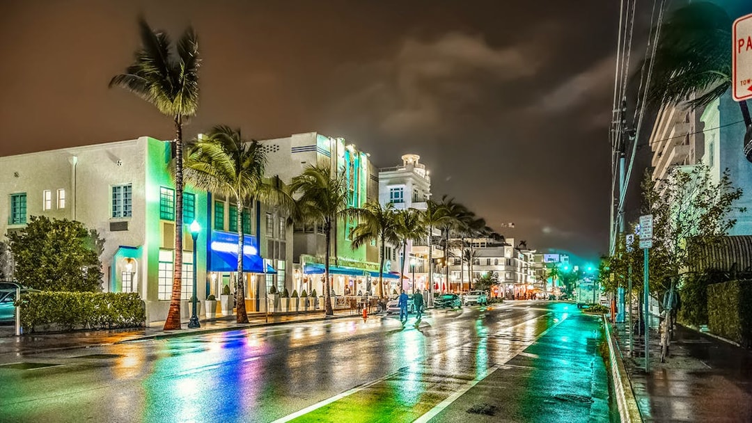 Miami's Ocean Drive at night with neon lights and art deco buildings.