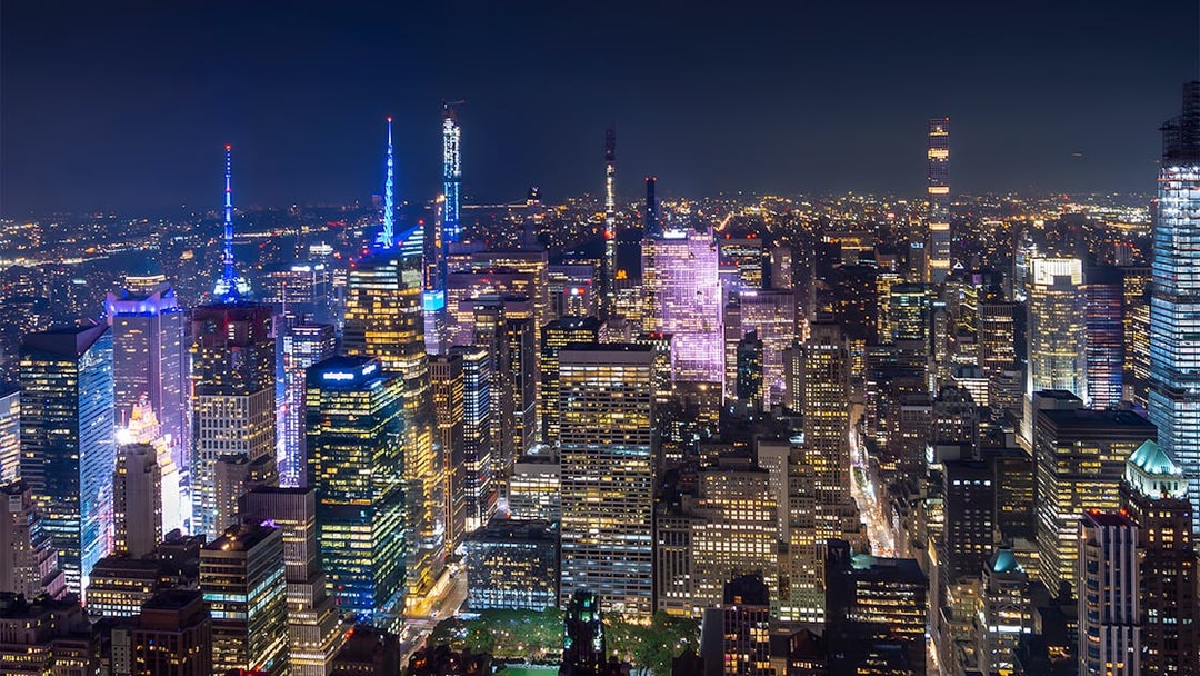 New York City skyline illuminated at night during Big Bus Night Tour.