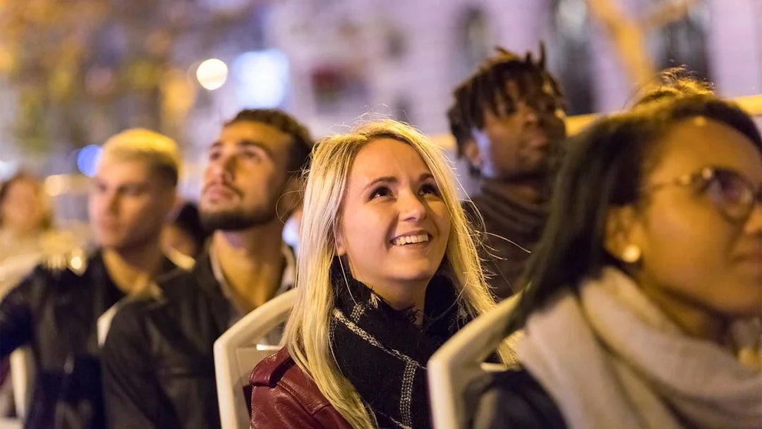 Passengers enjoying the Big Bus Paris Panoramic Night Tour.