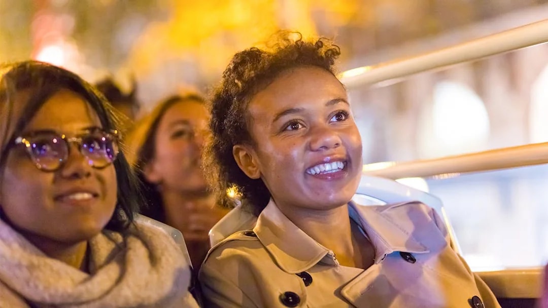 Passengers enjoying the Big Bus Paris Panoramic Night Tour.