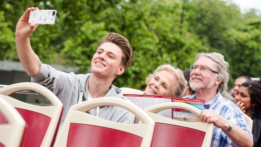 Family taking a selfie on a Big Bus hop on hop off tour.