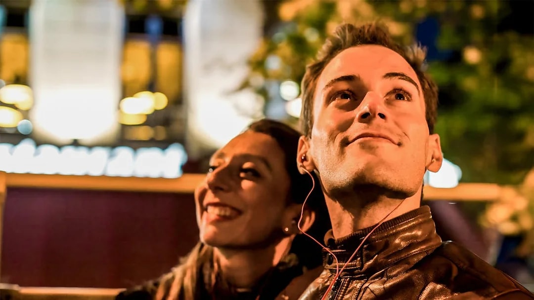 Couple enjoying Christmas lights on a night tour in San Francisco.