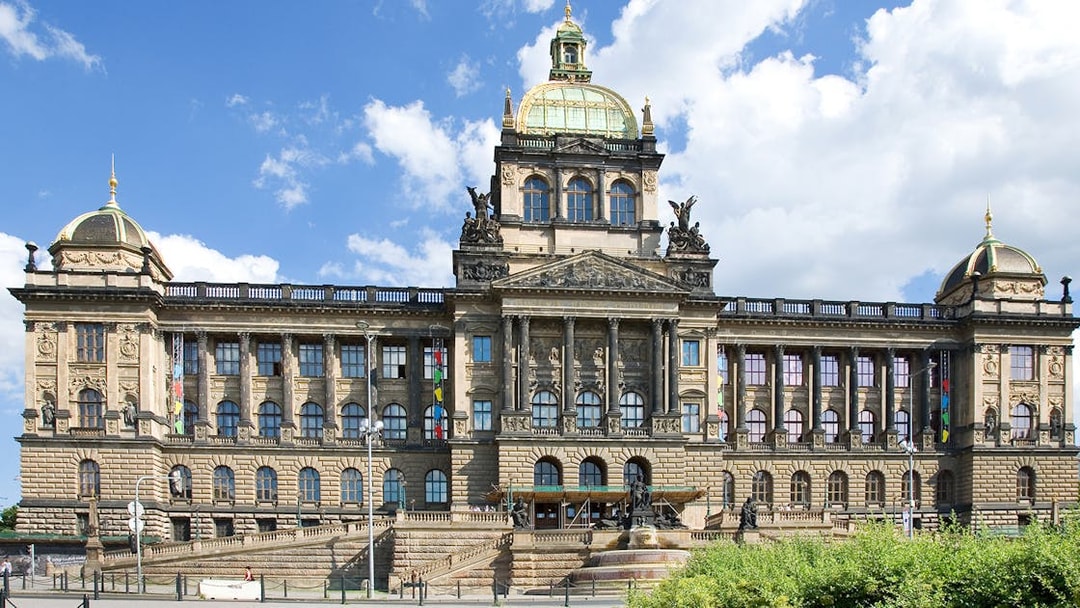 Prague National Museum facade under a clear blue sky.