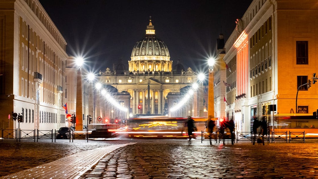 St. Peter's Basilica illuminated at night during Big Bus Rome tour.