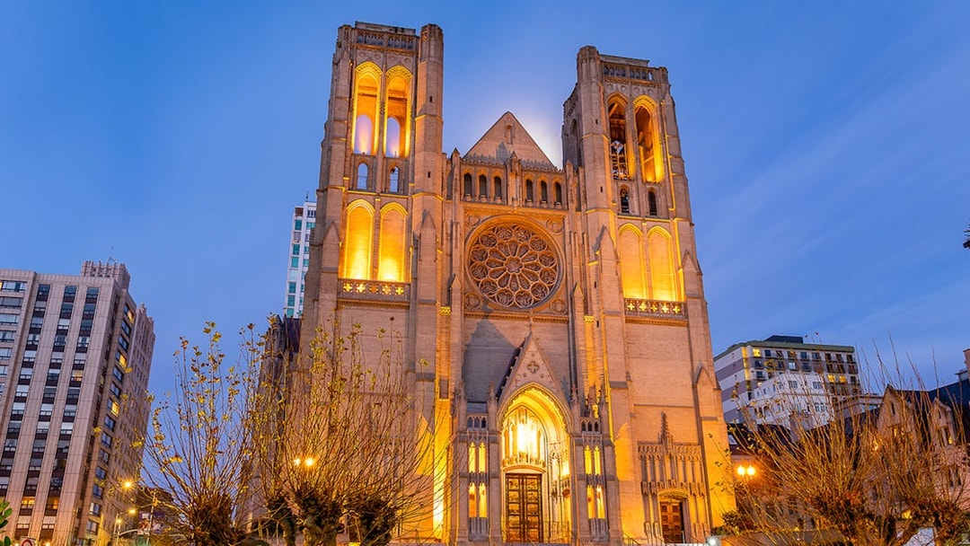 Grace Cathedral illuminated at sunset during Big Bus 1-Hr Sunset Tour in San Francisco.