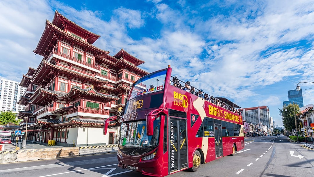 Tourists on a Singapore Hop-On-Hop-Off bus passing the Buddha Tooth Relic Temple.