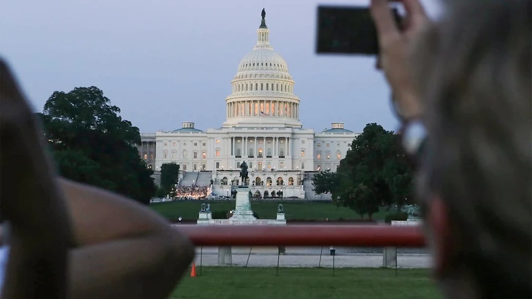 U.S. Capitol building at dusk viewed from a tour bus during a Big Bus 2-hour night tour.