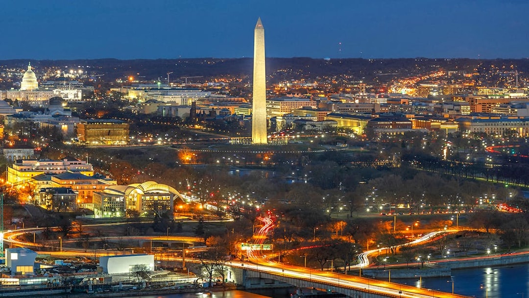 Washington D.C. night skyline with Washington Monument and Capitol Building on Big Bus tour route.