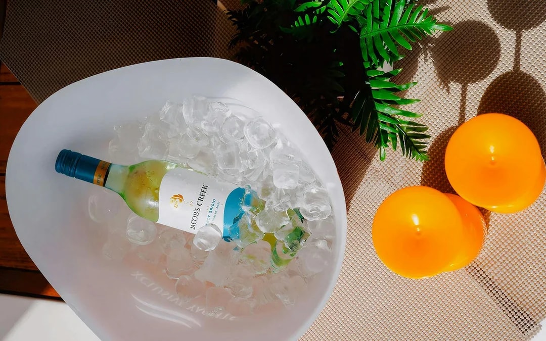 Wine bottle in ice bucket on luxury yacht, Dubai.