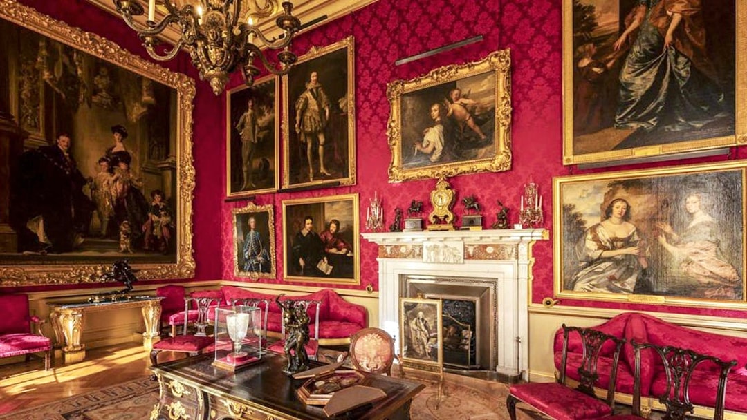 Blenheim Palace State Room with ornate paintings and luxurious red decor.