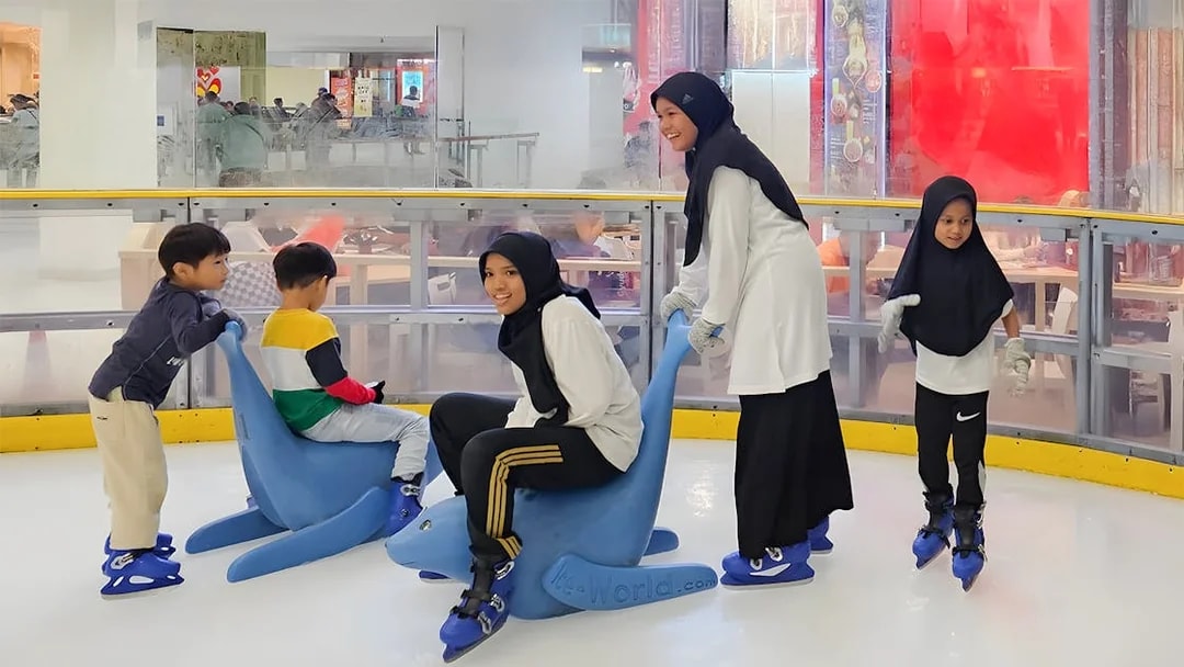 Kids using support aids for ice skating at Blue Ice Snow Park.