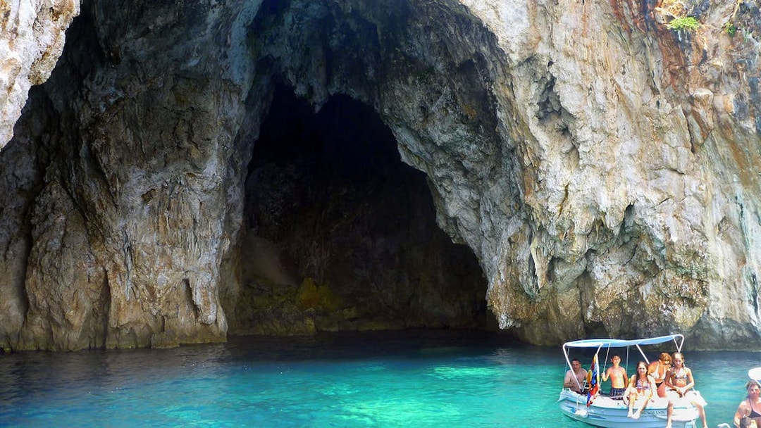 Boat entering sea cave on Blue Lagoon & Sivota cruise from Corfu.
