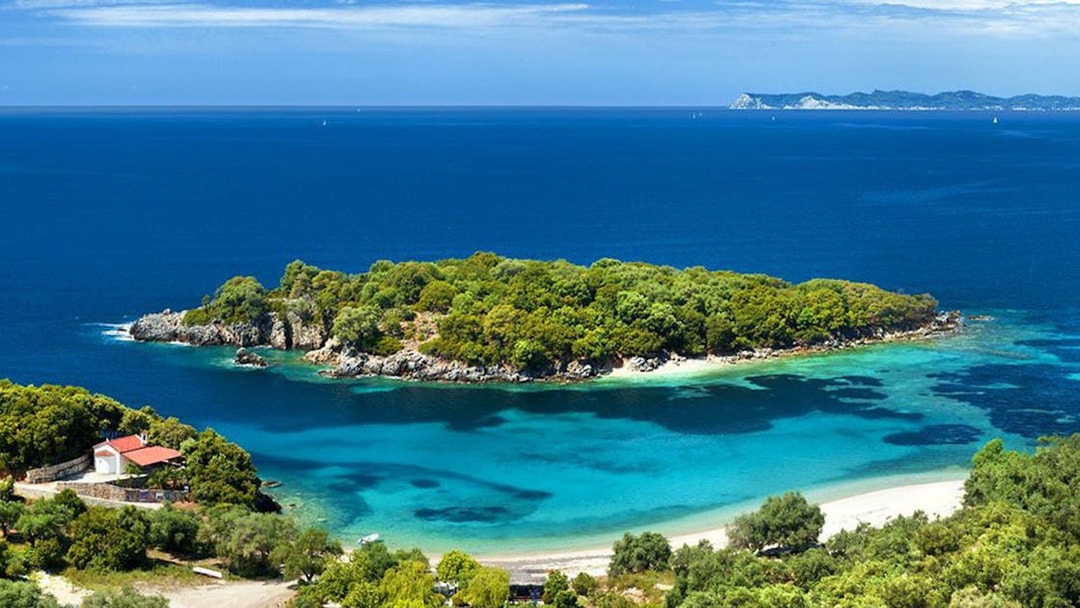 Blue Lagoon with lush greenery and clear waters on Sivota cruise from Corfu.
