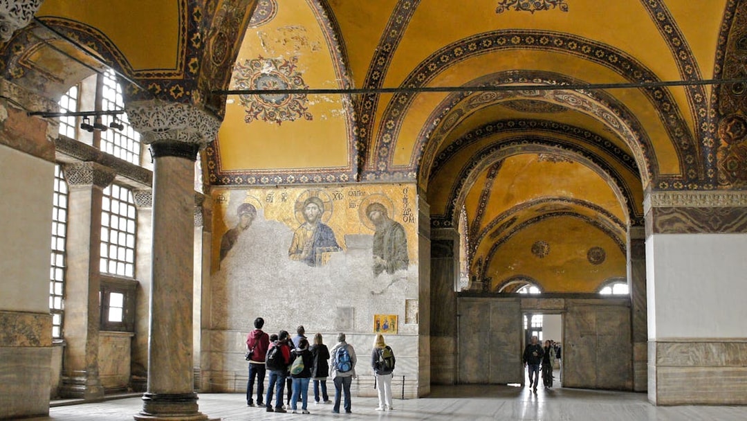 Visitors viewing Deesis mosaic in Hagia Sophia, Istanbul, Turkey.