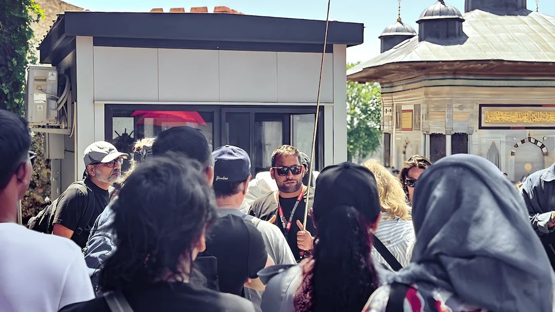 Tour guide leading a group near the Blue Mosque in Istanbul.