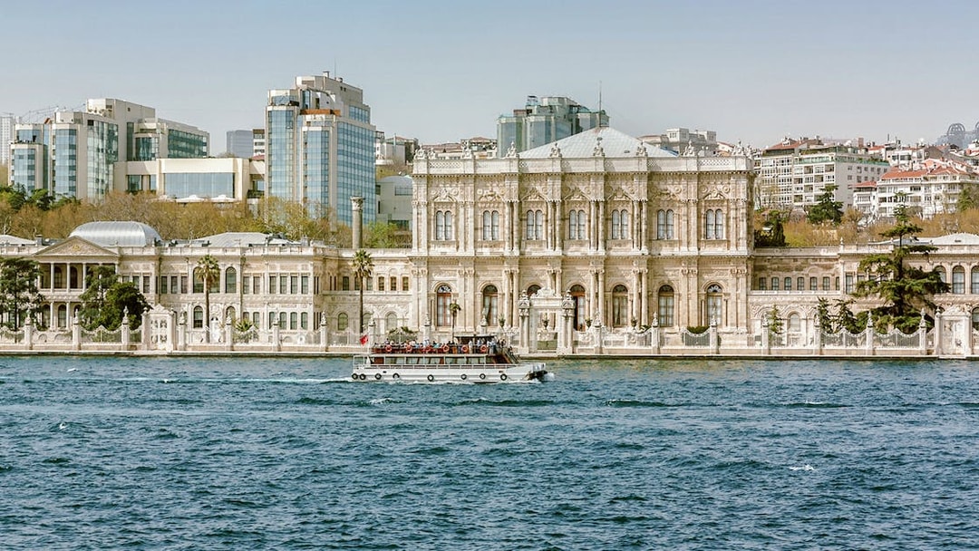 Dolmabahçe Palace in Istanbul with a boat on the Bosphorus.