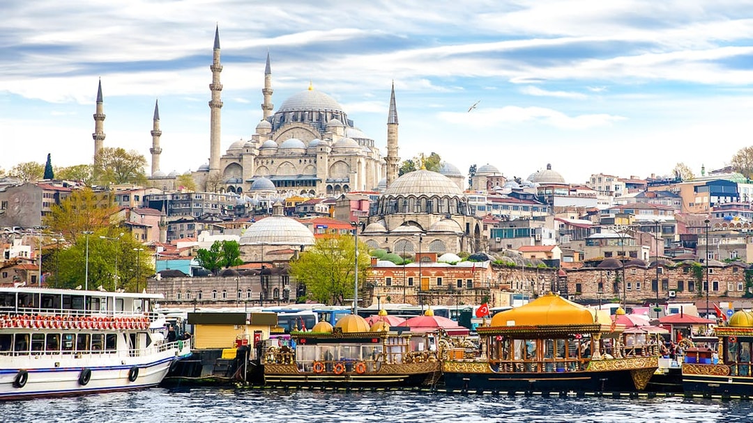 Boats on the Bosphorus with Suleymaniye Mosque in Istanbul, Turkey.