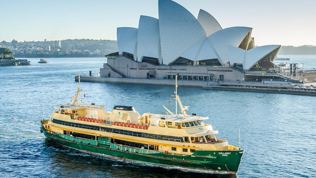 Ferry crossing Sydney Harbour with the Opera House in the background.