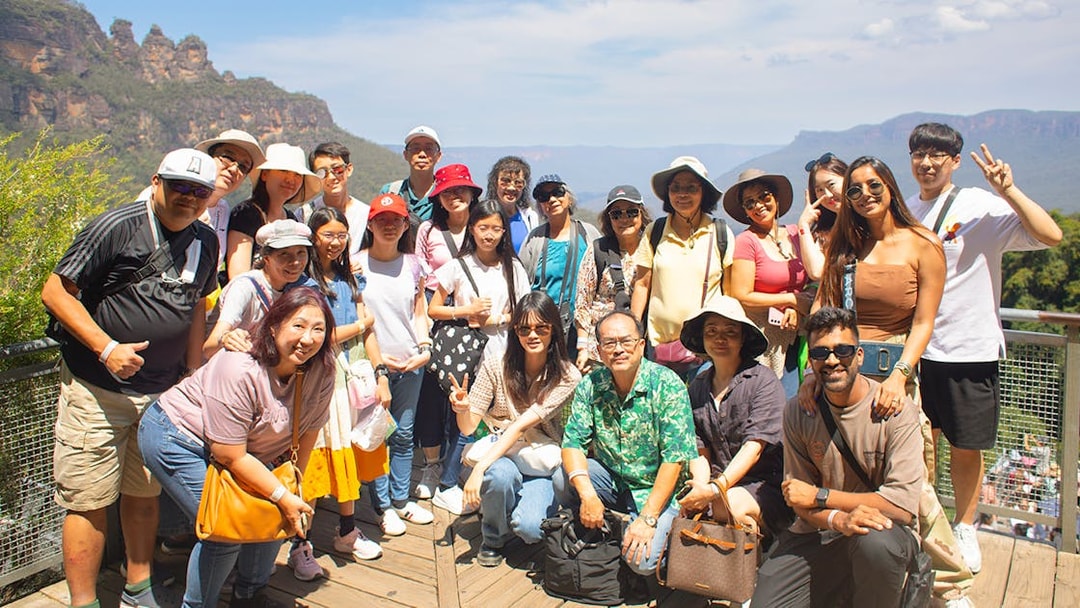 Group of tourists at Blue Mountains lookout during Sydney tour.