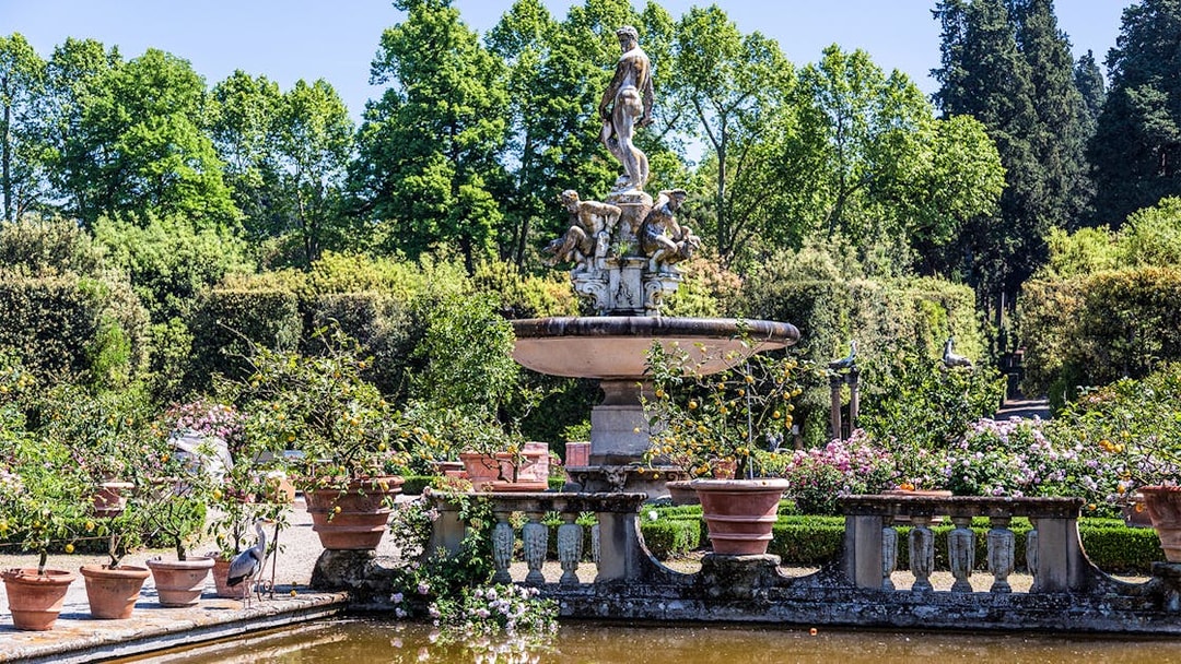 Fountain with statues surrounded by greenery in Boboli Gardens, Florence.