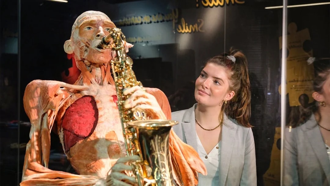 Sculpted human figure playing saxophone at Body Worlds Amsterdam exhibit.