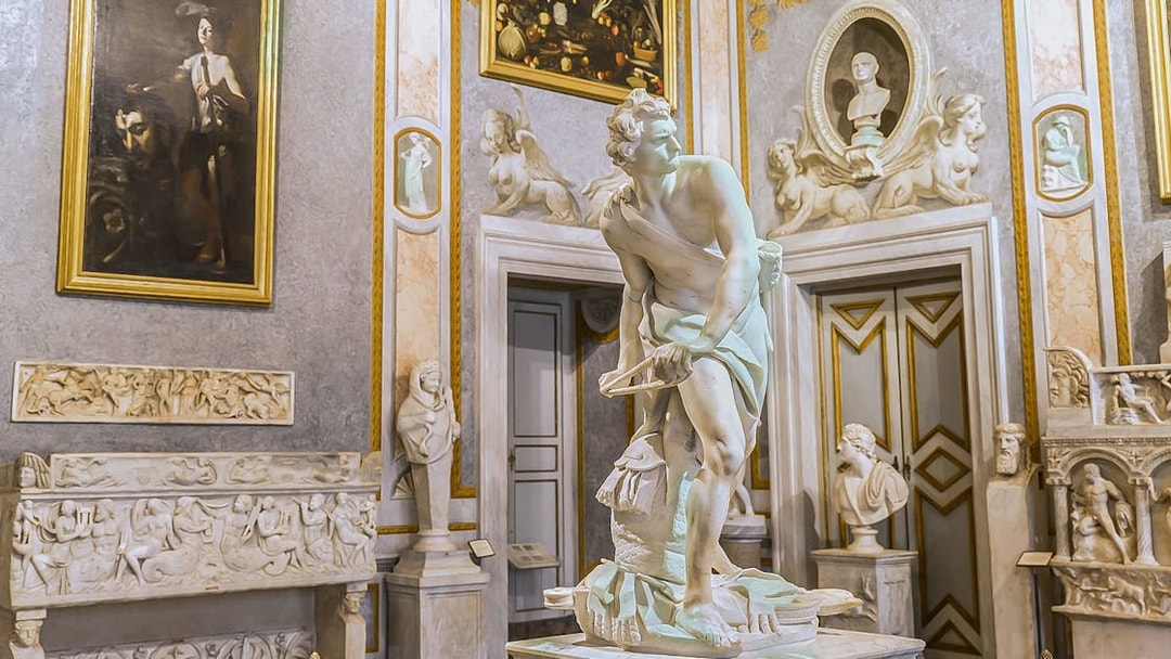 Bernini's David sculpture in Borghese Museum, Rome, surrounded by classical art.