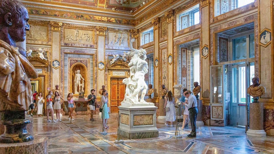 Tourists viewing sculptures at Borghese Gallery in Rome with skip-the-line tickets.