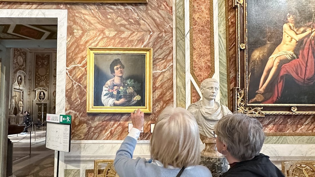 Visitors viewing Caravaggio's "Boy with a Basket of Fruit" at Borghese Gallery, Rome.