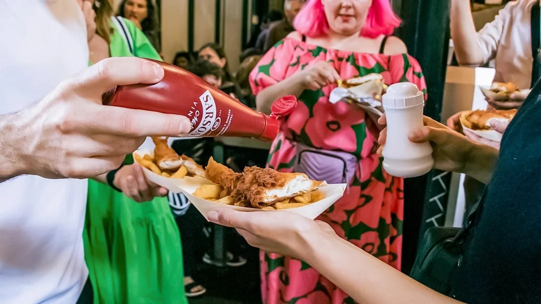 People enjoying fish and chips at Borough Market on the Bankside Food Tour in London.