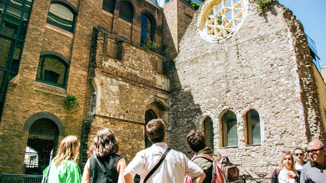 Visitors exploring historic ruins on the Eating London: Borough Market & Bankside Food Tour.