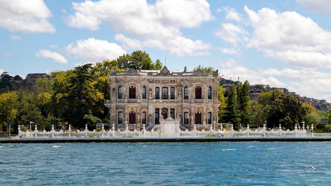 Kksu Pavilion by the Bosphorus in Istanbul, surrounded by trees and water.