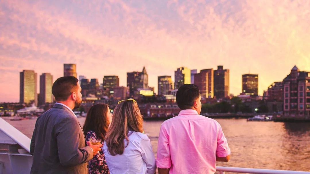 Guests enjoying Boston skyline on sunset cruise.