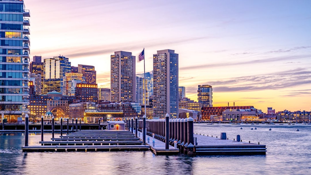 Boston downtown skyscrapers at sunset viewed from the waterfront.