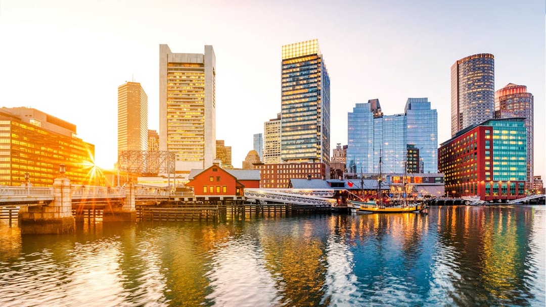 Boston Harbor and Financial District skyline at sunset, Massachusetts, USA.