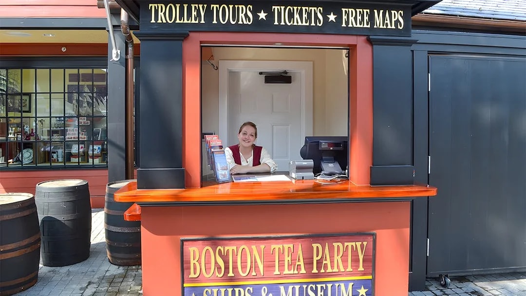 Ticket counter at Boston Tea Party Ships & Museum with staff member.