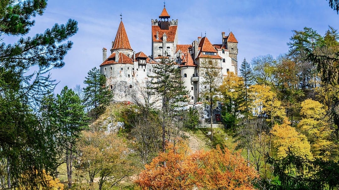 Bran Castle surrounded by autumn trees, Romania.