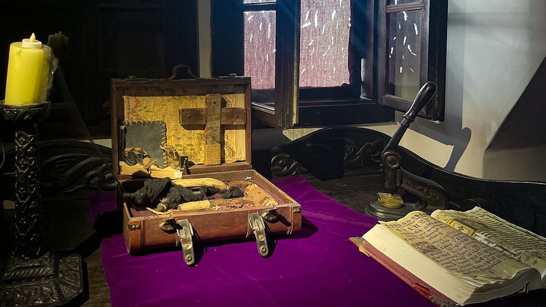 Bran Castle interior with a vampire hunting kit and ancient book on a table.