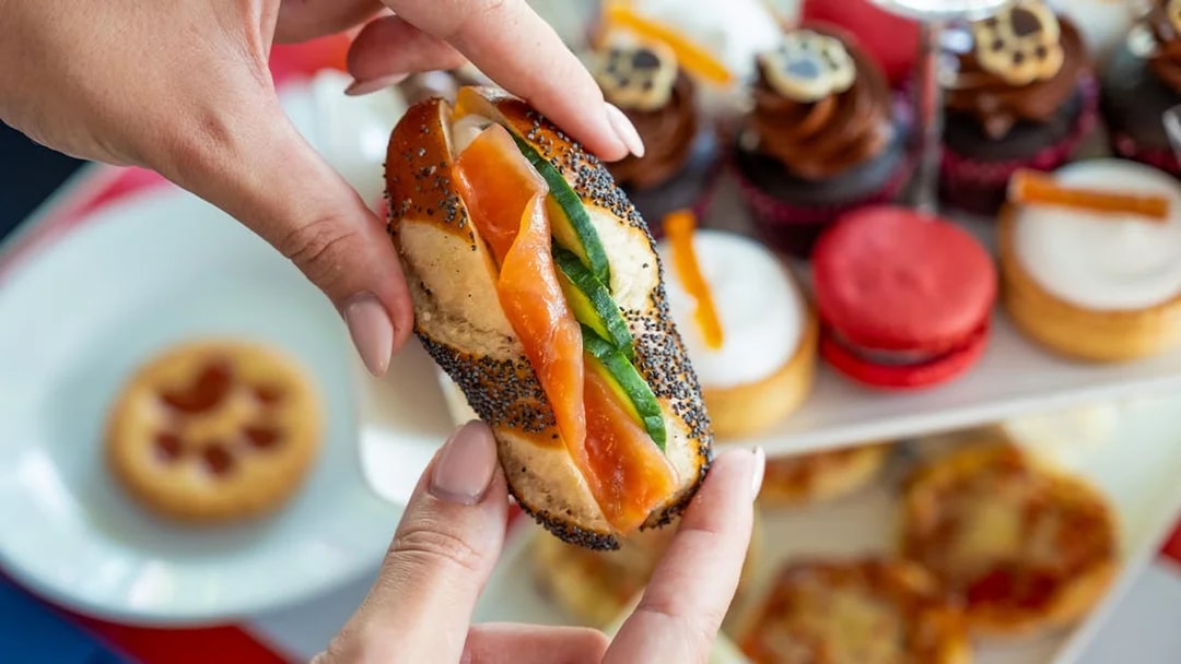Smoked salmon sandwich and pastries on Paddington Afternoon Tea Bus.