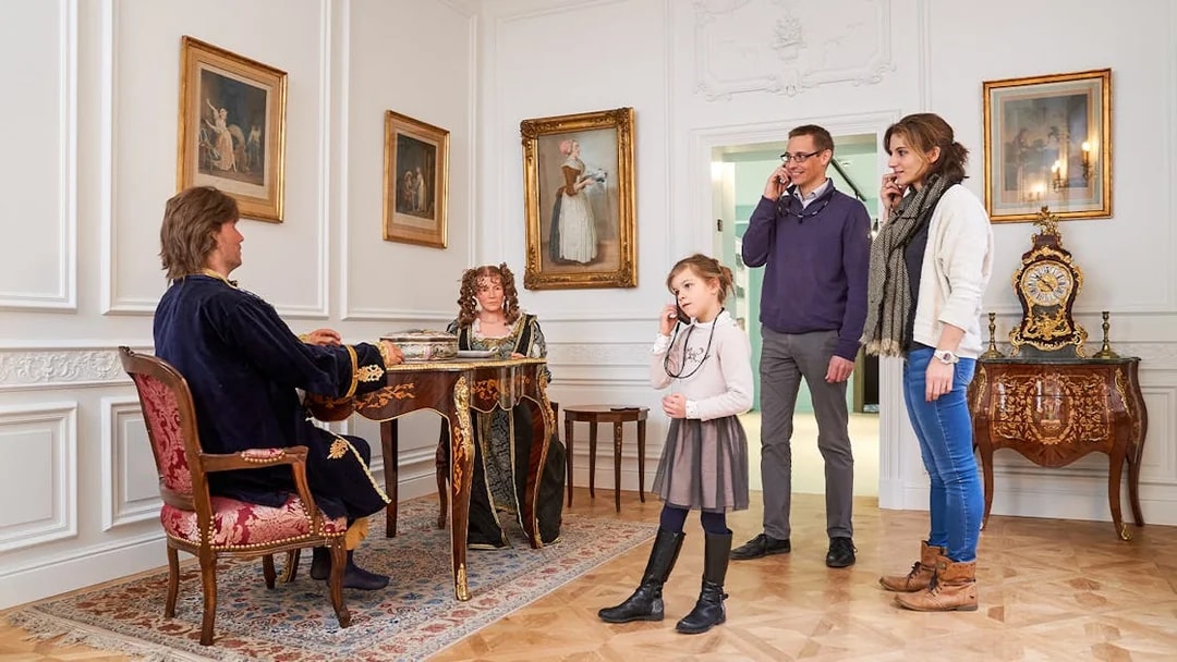 Tourists listening to an audio guide at Choco Story museum in Brussels.
