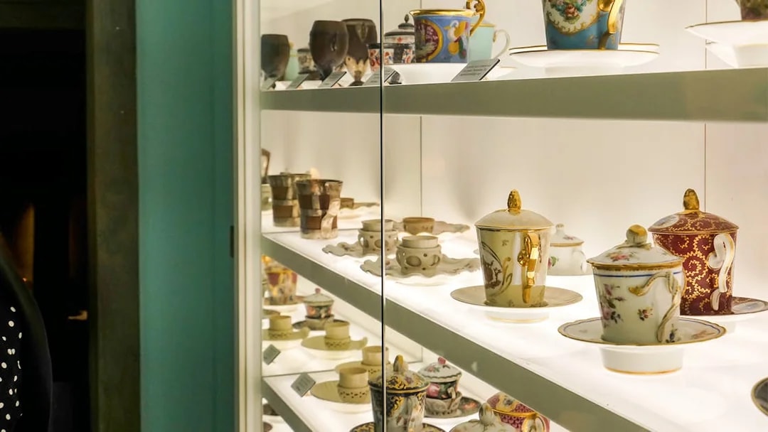 Antique chocolate cups displayed at Choco Story Brussels museum exhibit.