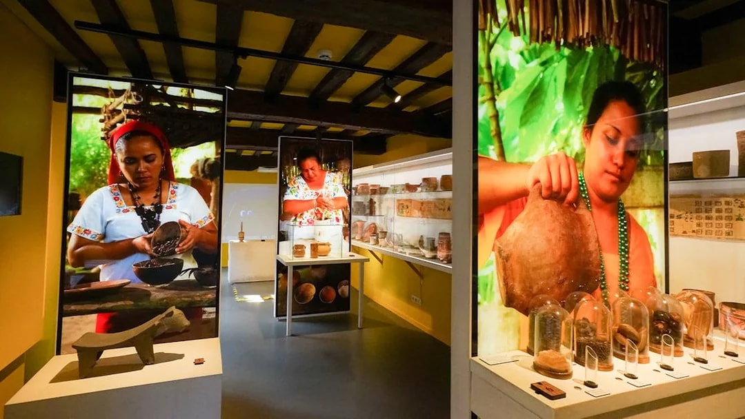 Tourists exploring chocolate exhibits at Choco Story museum in Brussels.