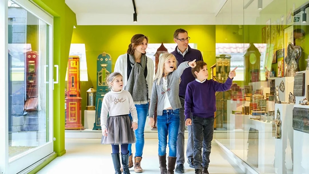 Family exploring exhibits at Choco Story Brussels museum.