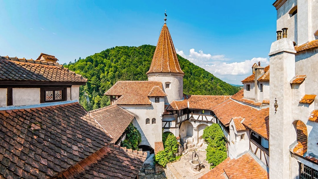 Bran Castle courtyard with view of Donjon tower and surrounding hills.