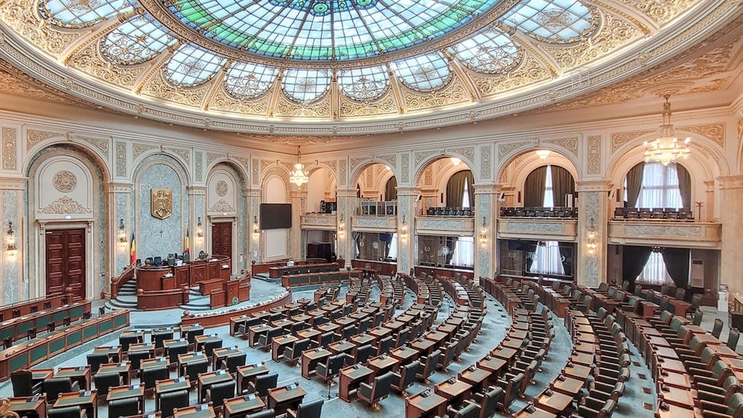 Parliament chamber with ornate ceiling inside Palace of Parliament, Bucharest.