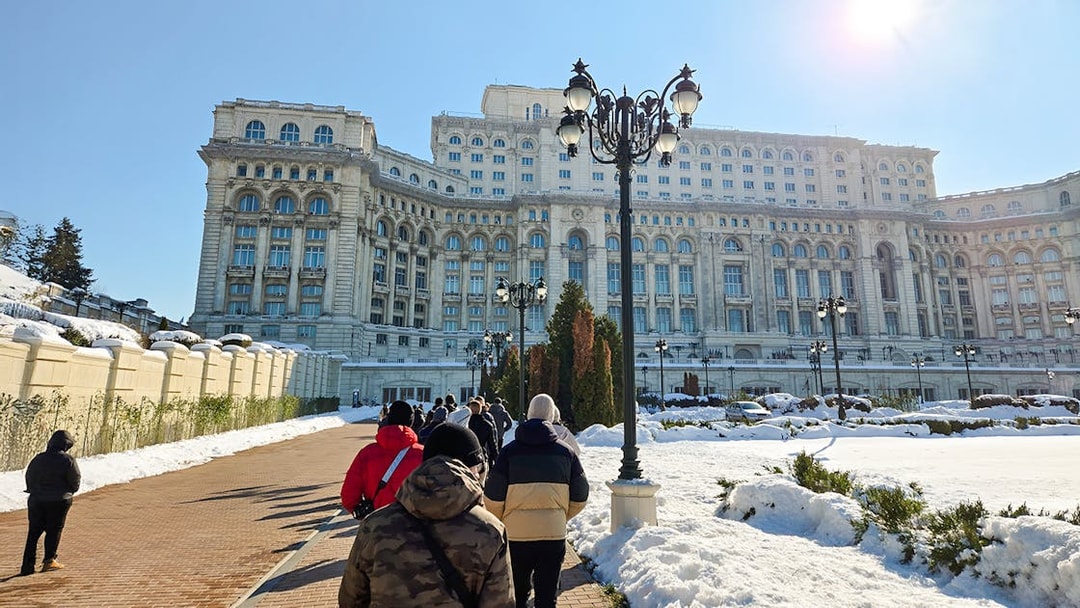 Visitors walking towards the Palace of Parliament in Bucharest, Romania.