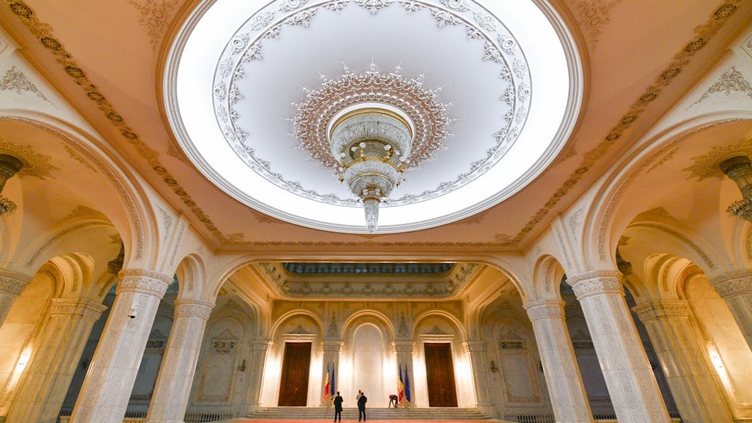 Tour group inside the grand hall of the Palace of Parliament, Bucharest, Romania.